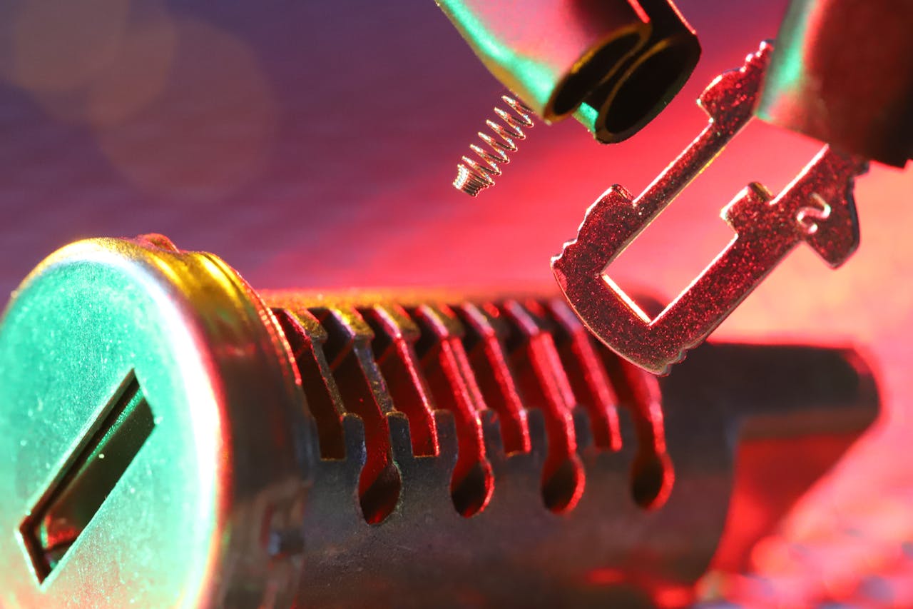 service-05 Macro shot of a mechanical lock cylinder and key, highlighting detailed components under vibrant lighting.
