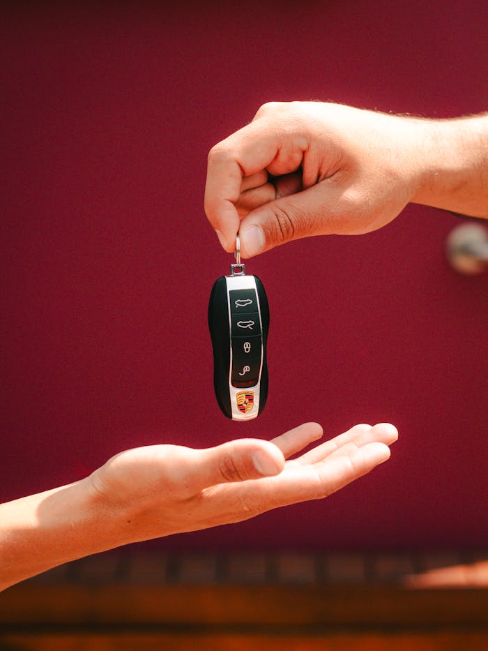 The Art of Drawing Readers In: Your attractive post title goes here Close-up of hands exchanging a luxury car key in São Paulo, Brazil.