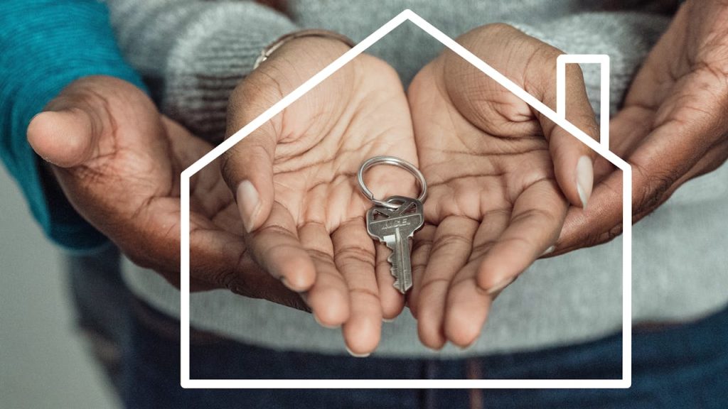 About Hands of a couple holding a house key symbolizing home ownership and new beginnings.